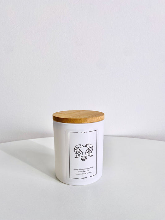 An Aries candle, depicting a ram's head, scented orange, cinnamon and patchouli