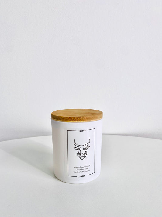 A Taurus candle, depicting a bull's head, scented orange, clove and patchouli